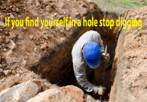 man deep in a hole digging