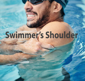 Male swimmer holding a painful left shoulder