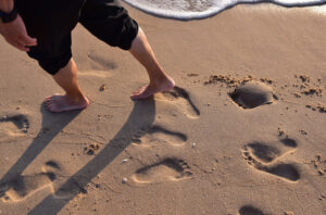 barefoot on vacation walking on beach